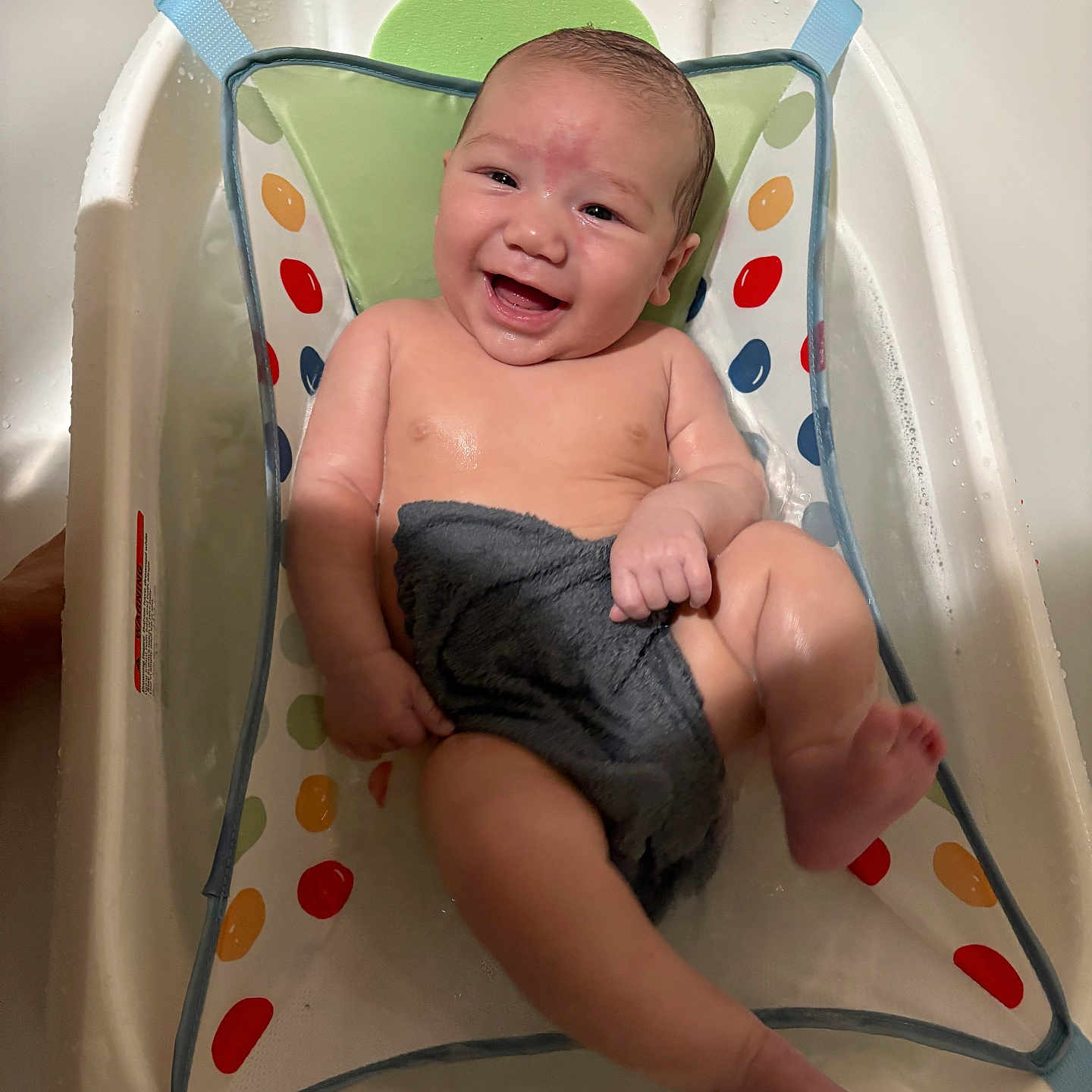 Damien is registered to the contest to win money with this photo: baby, babylaughing, bathing, bathtub, bodypart, crib, crying, face, finger, furniture, hand, happy, head, infantbed, newborn, person, photography, portrait, sad, tub