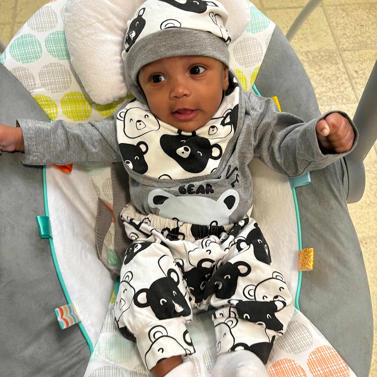 Kobe is registered to the contest to win money with this photo: baby, bodypart, bonnet, cap, clothing, couch, cushion, face, finger, furniture, hand, hat, head, hood, knitwear, person, photography, portrait, sitting, sweater