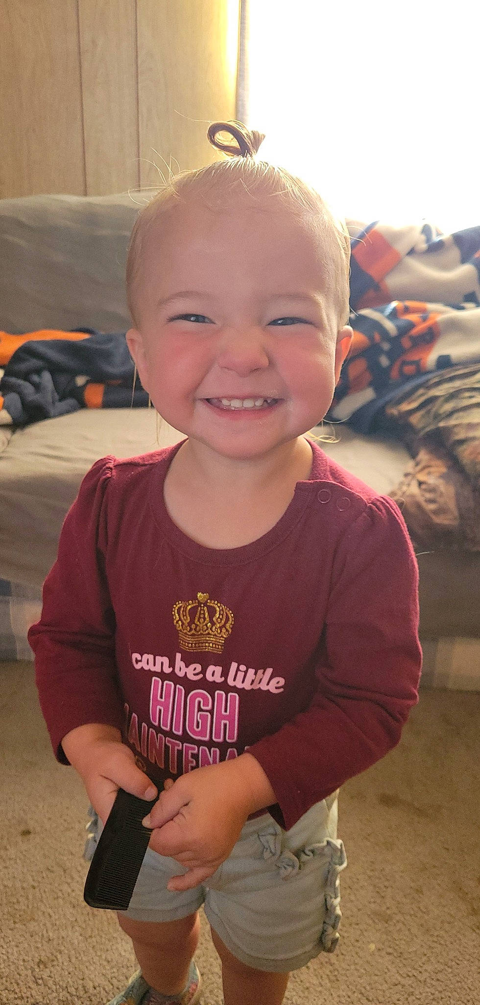 Nancy is registered to the contest to win money with this photo: arm, baby_toddler_clothing, cheek, eye, finger, forehead, fun, happy, head, iris, joy, mouth, nose, organ, person, pink, skin, sleeve, smile, standing