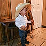 Wilder joined the competition — help win amazing prizes! child, boy, cowboy_hat, boots, jeans, belt, white_shirt, indoor, tile_floor, wooden_furniture, wooden_horse, thumbs_up, side_view, smiling, cute, decor, door, wall, standing, portrait