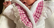 Waïlee participe au concours pour gagner de l'argent avec cette photo : baby, infant, child, robe, pink, white, lace, clothing, cute, portrait, face, hands, soft, cushion, indoor, newborn, sleepwear, relaxed, person, cozy