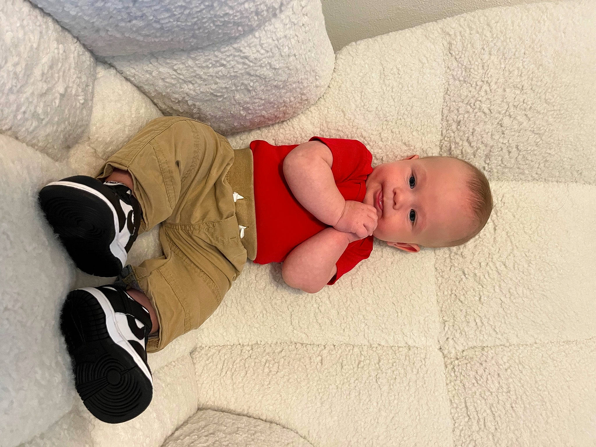 Declan is registered to the contest to win money with this photo: baby, baby_sleeping, baby_toddler_clothing, carmine, child, comfort, floor, flooring, foot, human_leg, knee, linens, mammal, person, product, sitting, sock, textile, thigh, toddler