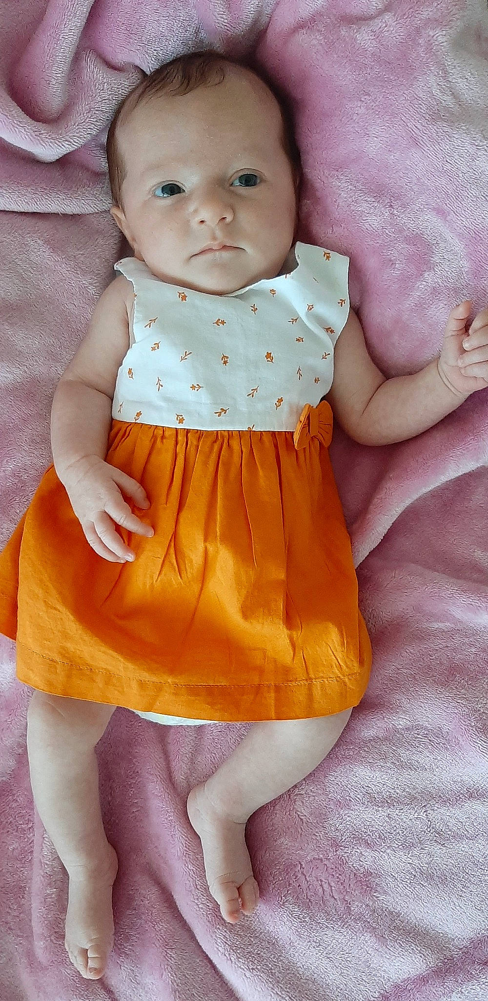 Kayna participe au concours pour gagner de l'argent avec cette photo : arm, baby, baby_toddler_clothing, cheek, day_dress, dress, face, finger, hand, iris, lip, neck, one_piece_garment, outerwear, person, pink, skin, sleeve, toddler, waist