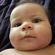 Theodore joined the competition — help win amazing prizes! baby, infant, child, face, portrait, close_up, chubby_cheeks, large_eyes, curious, neutral_expression, bare_shoulders, skin, head, eyes, nose, mouth, dark_background, fabric, indoor, photography
