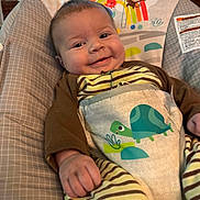 Theodore joined the competition — help win amazing prizes! baby, infant, child, smiling, portrait, sitting, bouncer, baby_seat, striped_clothing, turtle, animal_pattern, blanket, cushion, indoor, home, sunlight, window, bamboo_shades, happy, face