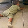 Emiliano joined the competition — help win amazing prizes! baby, crawling, floor, tile, sock, nike, table, wood, carving, child, indoor, curious, exploration, furniture, infant, lightgreen, clothing, person, rearview, small