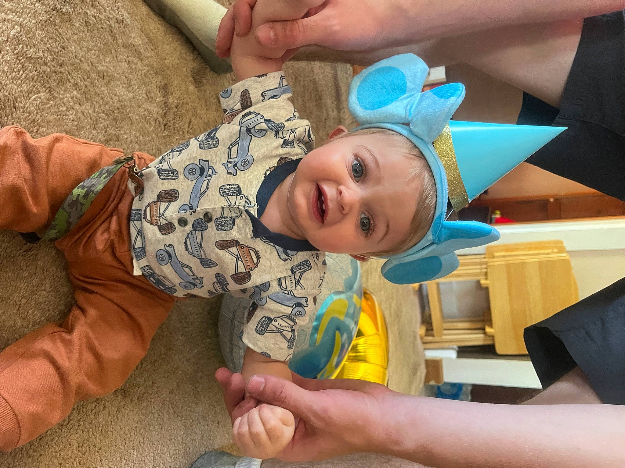 Micah is registered to the contest to win money with this photo: baby, baby_toddler_clothing, cheek, child, finger, flooring, fun, gesture, hand, happy, nail, person, play, room, skin, smile, textile, thumb, toddler, vacation