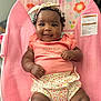 Zuri is registered to the contest to win money with this photo: baby, bow, chair, child, clothing, cute, floral, furniture, girl, happy, headband, indoors, infant, person, pink, polka_dot, portrait, sitting, skin, smiling
