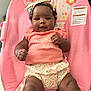 Zuri joined the competition — help win amazing prizes! adorable, baby, baby_chair, child, chubby, clothing, comfortable, curly_hair, cute, floral, headband, indoors, infant, person, pink, portrait, sitting, smiling, warning_label, young_child