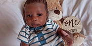 Taige joined the competition — help win amazing prizes! baby, blanket, blue, child, cute, face, hand, indoors, infant, milestone, newborn, one_month, person, plush_toy, portrait, soft, striped_clothing, teddy_bear, white, wooden_sign