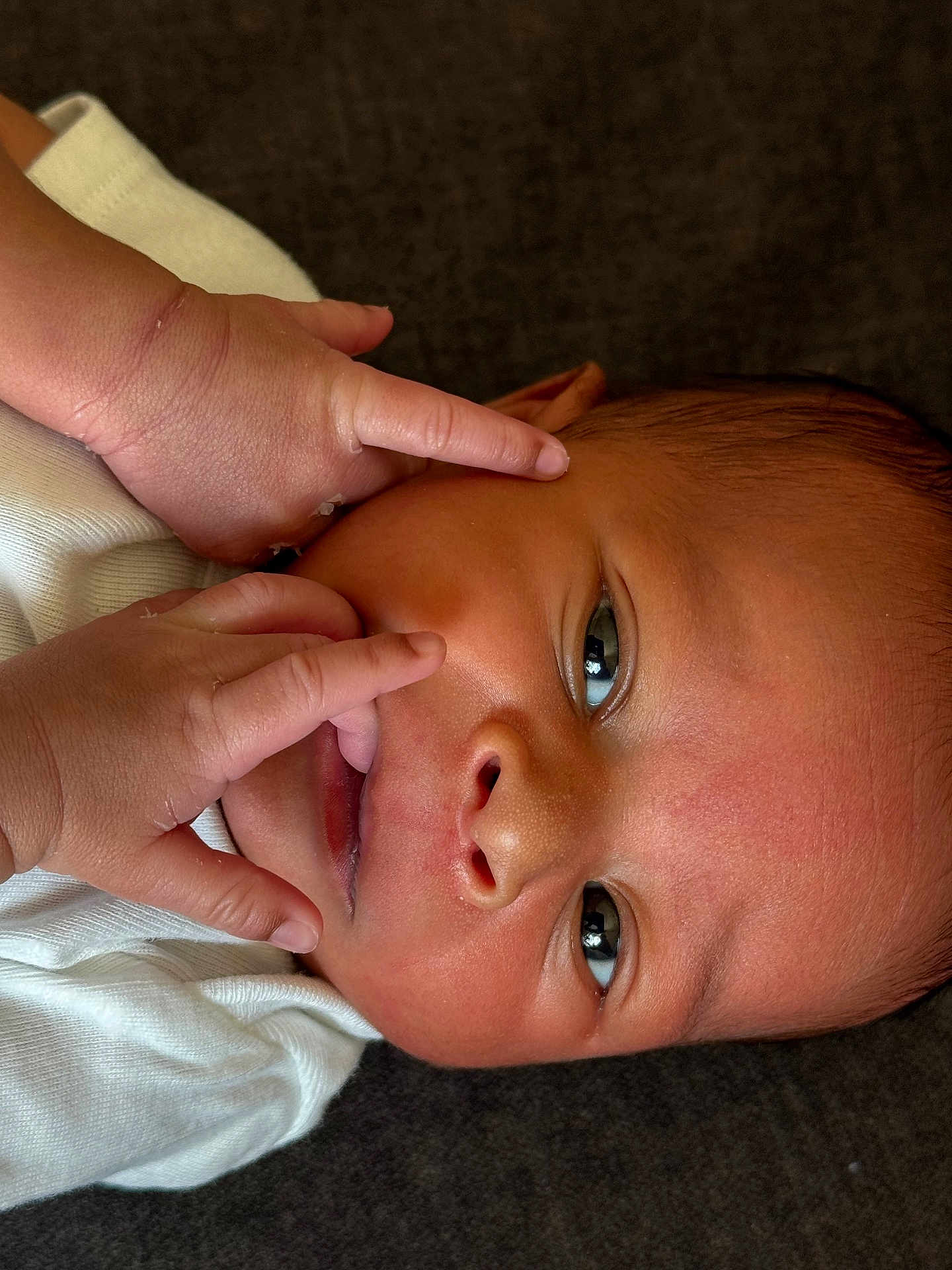 Taige joined the competition — help win amazing prizes! baby, newborn, infant, face, hands, white_clothing, curious, close_up, skin, eyes, lying_down, soft_texture, cute, tiny_fingers, portrait, child, newborn_baby, human, head, expression