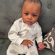 Taige joined the competition — help win amazing prizes! baby, infant, pajamas, elephant_print, couch, gray_couch, pillow, patterned_pillow, indoor, child, person, seated, looking_at_camera, cute, cozy, soft_fabric, home, portrait, young_child, furniture