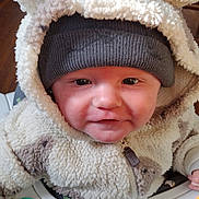 Tristan joined the competition — help win amazing prizes! baby, infant, toddler, hood, beanie, fluffy_jacket, cute, smile, cheeks, eyes, face, highchair, toy, zipper, indoor, wood_floor, table, skin, portrait, clothing