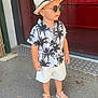 toddler, child, boy, hat, sunglasses, shorts, shirt, sandals, sidewalk, urban, outdoor, fashion, summer, palm_tree_pattern, street, casual, standing, person, accessory, cool