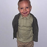 Kaïs a rejoint le concours — aidez-le/la à gagner de superbes lots ! toddler, child, boy, standing, smiling, polo_shirt, cardigan, pants, indoor, portrait, hairstyle, neat, confident, white_wall, casual_clothing, cute, young_child, fashion, person, human