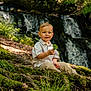 Kaïs participe au concours pour gagner de l'argent avec cette photo : child, toddler, forest, moss, roots, waterfall, nature, leaf, outdoor, greenery, curious, clothing, pants, shirt, sitting, daylight, young, person, natural_light, scenery