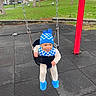 Angel joined the competition — help win amazing prizes! toddler, child, swing, playground, blue_hat, blue_bib, blue_slippers, black_swing, grass, trees, outdoor, park, happy, smiling, baby, clothing, footwear, daytime, fun, play