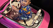 Angel joined the competition — help win amazing prizes! child, toddler, toy_car, pink_car, steering_wheel, pajamas, smiling, indoor, floor, wood_floor, seat, happy, playtime, cute, vehicle, small, baby, childhood, fun, joy