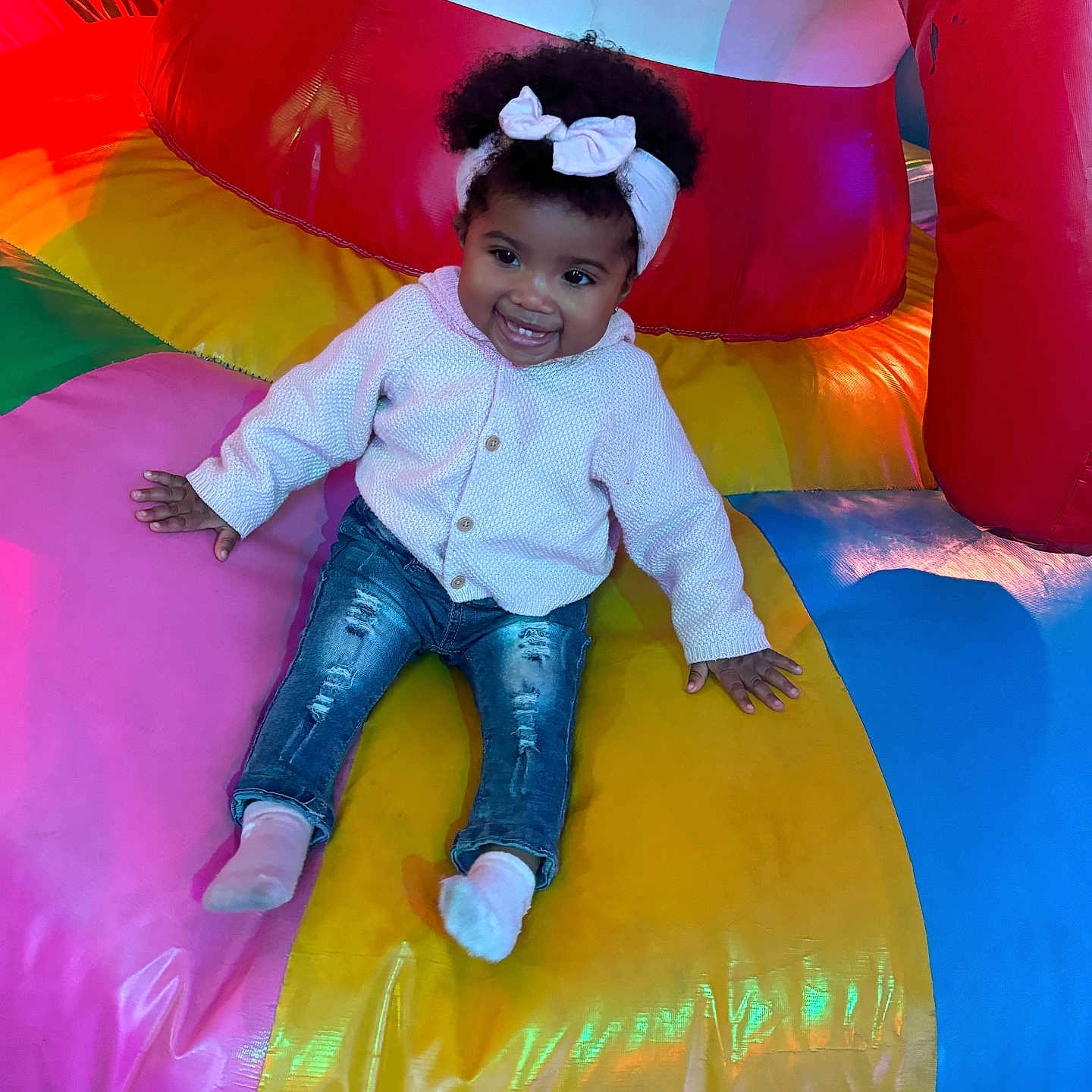 Marlee is registered to the contest to win money with this photo: baby, bodypart, clothing, face, finger, hand, head, hosiery, indoors, inflatable, jeans, outdoors, pants, person, photography, playarea, portrait, slide, sock, toy