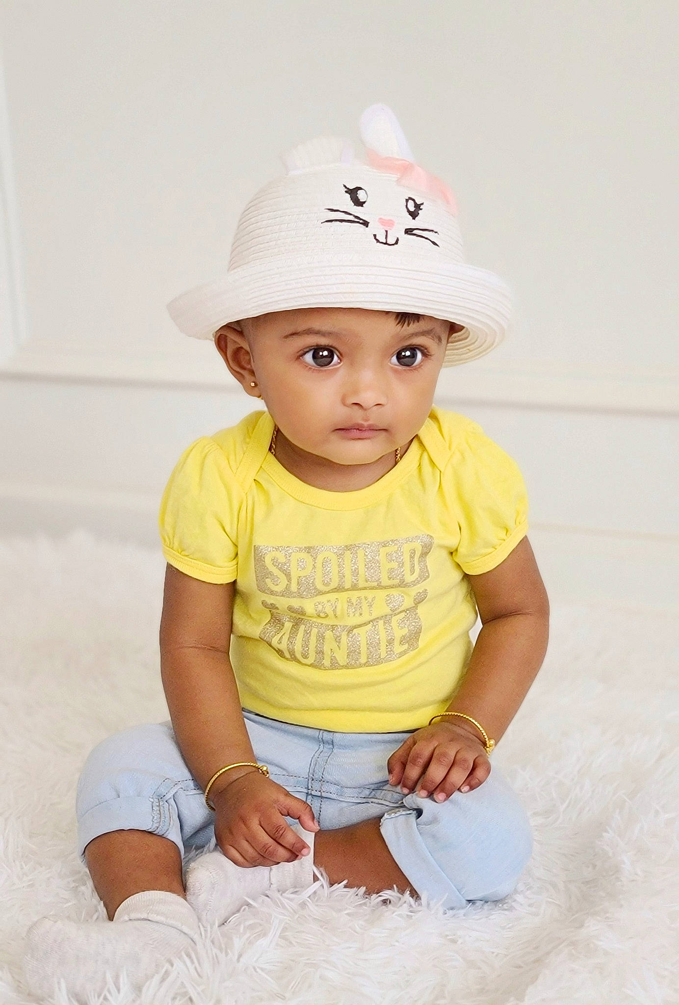 Shanaya Sinthujan joined the competition — help win amazing prizes! baby, baby_toddler_clothing, cap, child, child_model, clothing, costume_accessory, fashion_accessory, hat, headgear, headwear, person, product, sitting, sleeve, smile, sun_hat, t_shirt, toddler, white