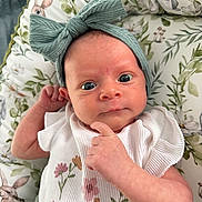 Sofia is registered to the contest to win money with this photo: baby, infant, headband, bow, floral, cute, cushion, bunny, pattern, clothing, portrait, indoors, child, skin, face, expression, hand, newborn, soft, lying