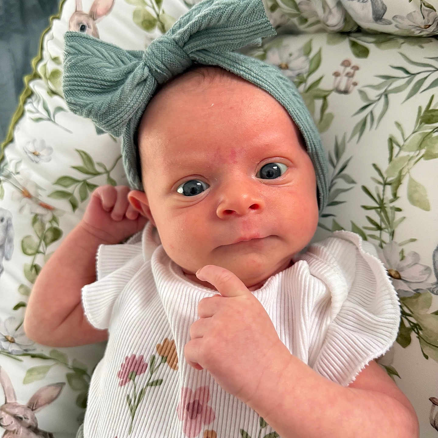 Sofia is registered to the contest to win money with this photo: baby, infant, headband, bow, floral, cute, cushion, bunny, pattern, clothing, portrait, indoors, child, skin, face, expression, hand, newborn, soft, lying
