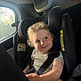 Simon participe au concours pour gagner de l'argent avec cette photo : toddler, child, car_seat, smile, curly_hair, seatbelt, car_interior, window, sunlight, happy, baby, face, person, clothing, headrest, seat, safety, cute, indoors, transport