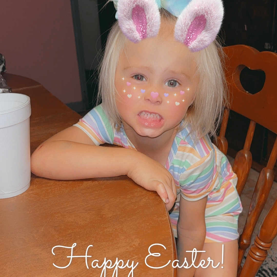 Anslie Rector is registered to the contest to win money with this photo: blonde_hair, bunny_ears_filter, carpet, child, child_interior, child_leaning, cute, digital_filter, doorway, easter, face_filter, fun, happy_easter_text, home, indoor, playful_expression, striped_clothing, table, wooden_chair, wooden_furniture