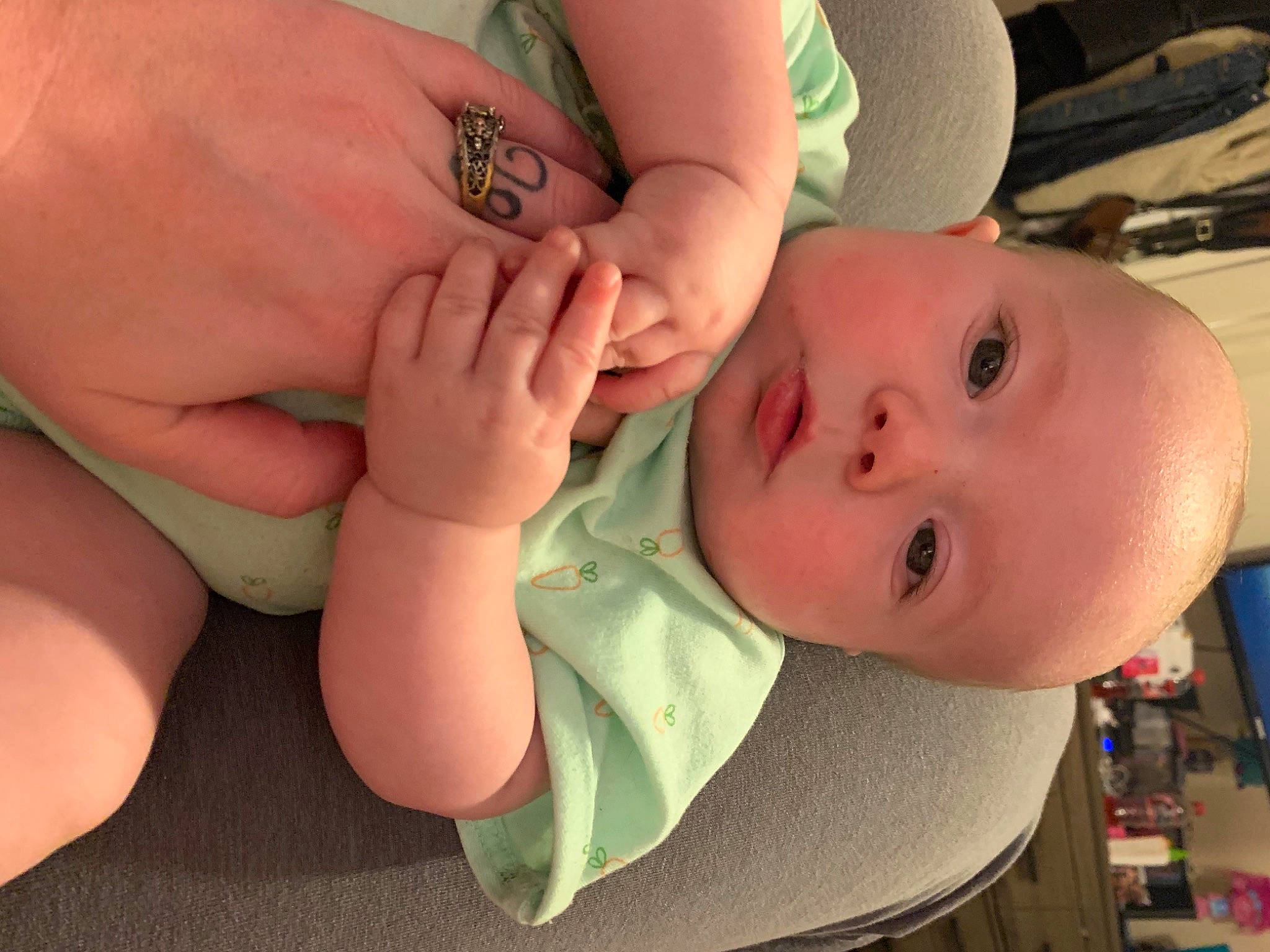 Benji is registered to the contest to win money with this photo: arm, baby, baby_toddler_clothing, cheek, eye, eyelash, finger, gesture, hand, happy, human_body, iris, joint, lip, mouth, neck, nose, person, skin, thumb