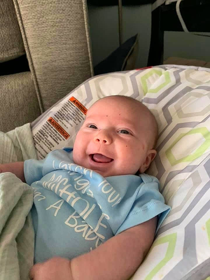 Benji is registered to the contest to win money with this photo: baby, baby_products, baby_toddler_clothing, bedtime, chair, cheek, child, comfort, eye, happy, iris, linens, mouth, nap, person, room, sitting, skin, sleep, smile