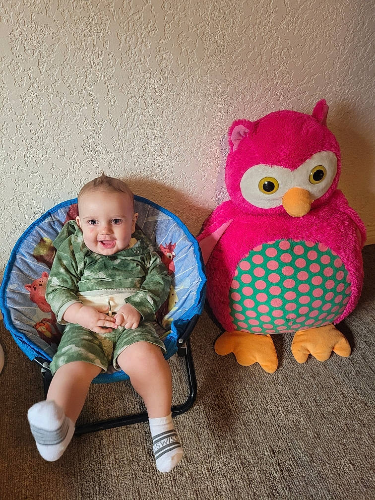 Axton joined the competition — help win amazing prizes! baby, baby_products, baby_toddler_clothing, beak, bird, chair, chicken, eye, happy, head, lap, leg, person, phasianidae, sleeve, smile, sock, stuffed_toy, t_shirt, toddler