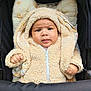 Kaelan participe au concours pour gagner de l'argent avec cette photo : baby, child, hoodie, stroller, cute, fluffy, beige, pillow, expression, face, infant, clothing, cozy, warm, portrait, sitting, hand, fur, zipper, indoors