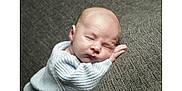 Albie is registered to the contest to win money with this photo: baby, newborn, sleeping, infant, couch, cushion, cozy, sweater, peaceful, resting, portrait, closeup, head, face, soft, cute, child, indoor, relaxation, comfort