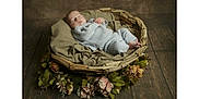 Albie is registered to the contest to win money with this photo: baby, basket, blanket, child, cozy, cushion, cute, decorative, flowers, indoor, infant, knitwear, natural_colors, newborn, peaceful, portrait, resting, sleeping, soft_lighting, wooden_floor