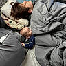 baby, child, person, sleeping, bed, blanket, pillow, indoor, rest, cozy, hand_holding, nap, comfort, family, blanket_fold, head, hair, clothing, peaceful, quiet