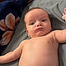 Elijah is registered to the contest to win money with this photo: arm, baby, bed, blanket, blue_eyes, candid, curious, diaper, expression, face, head, indoor, infant, lying_down, newborn, person, photography, puzzle, skin, soft