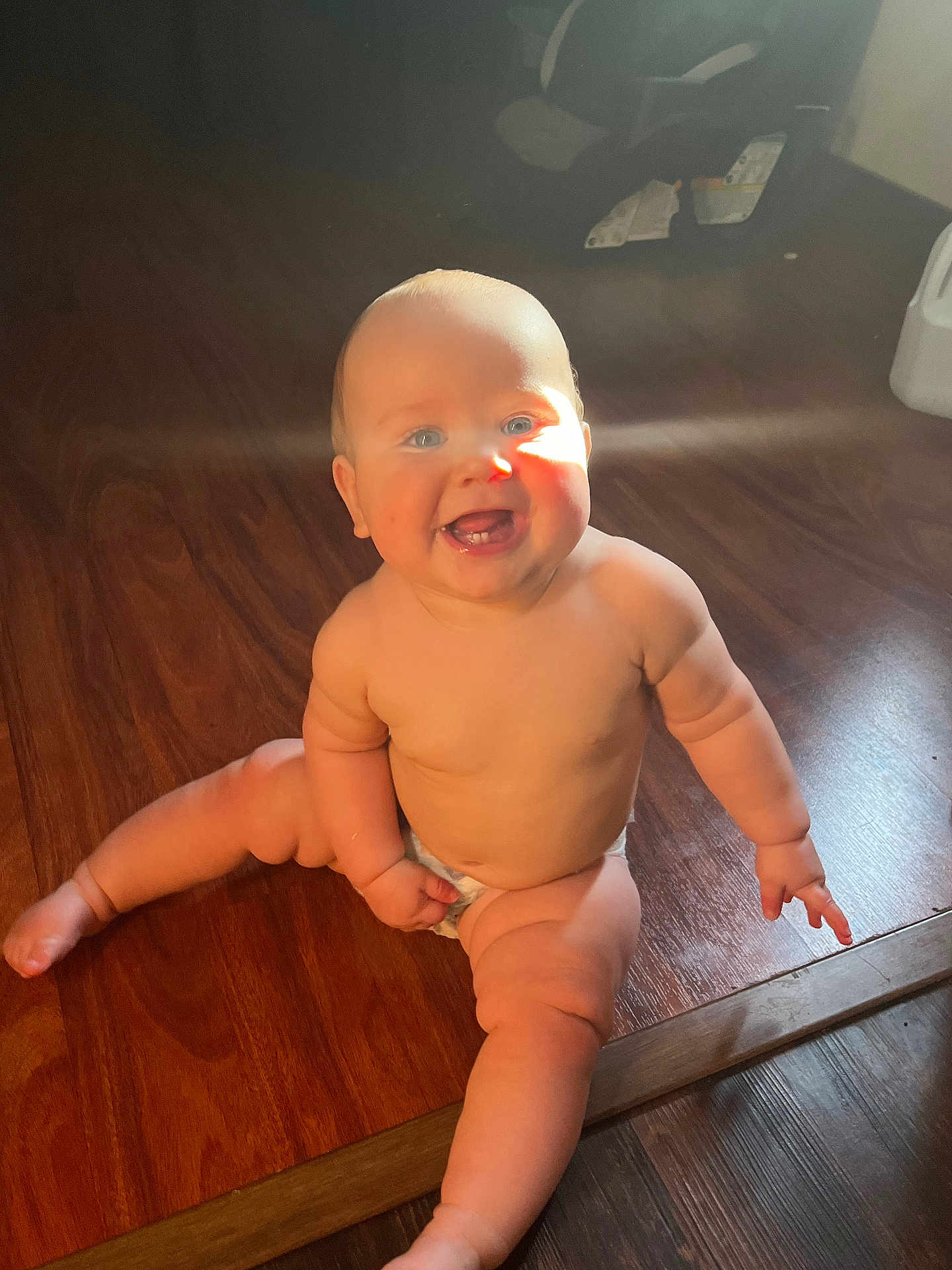 Declan joined the competition — help win amazing prizes! baby, child, smiling, sitting, wooden_floor, sunlight, diaper, happy, cute, infant, skin, legs, tooth, indoors, flooring, chubby, portrait, bright, natural_light, human