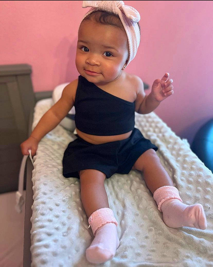 Lani joined the competition — help win amazing prizes! baby, baby_toddler_clothing, comfort, embellishment, finger, foot, human_body, human_leg, iris, knee, neck, pattern, person, pink, sitting, sleeve, sock, thigh, thumb, toddler