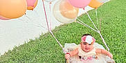Allyson joined the competition — help win amazing prizes! baby, balloon, basket, celebration, child, cute, dress, flower_headband, fun, grass, greenery, happy, nature, outdoor, pastel_colors, playful, portrait, smiling, toddler, wicker
