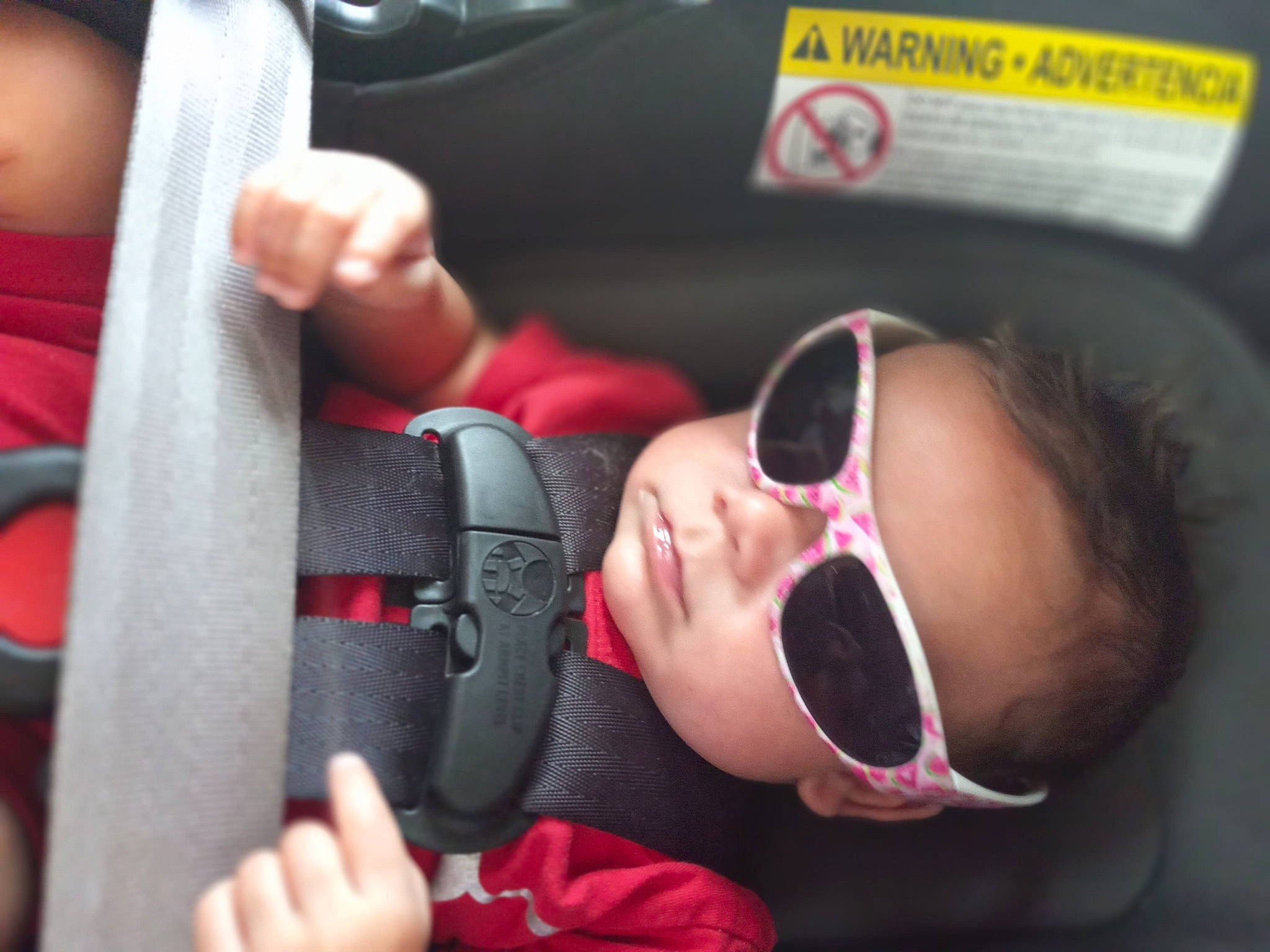 Ashton is registered to the contest to win money with this photo: audio_equipment, baby, car_seat, child, close_up, comfort, ear, entertainment, event, eyewear, finger, fun, glasses, goggles, nail, nose, person, personal_protective_equipment, sunglasses, toddler