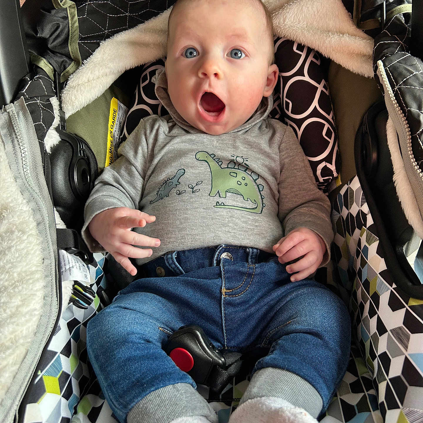 James is registered to the contest to win money with this photo: baby, bodypart, car, clothing, face, finger, footwear, furniture, head, jeans, pants, person, photography, portrait, shoe, shorts, stroller, t_shirt, transportation, vehicle