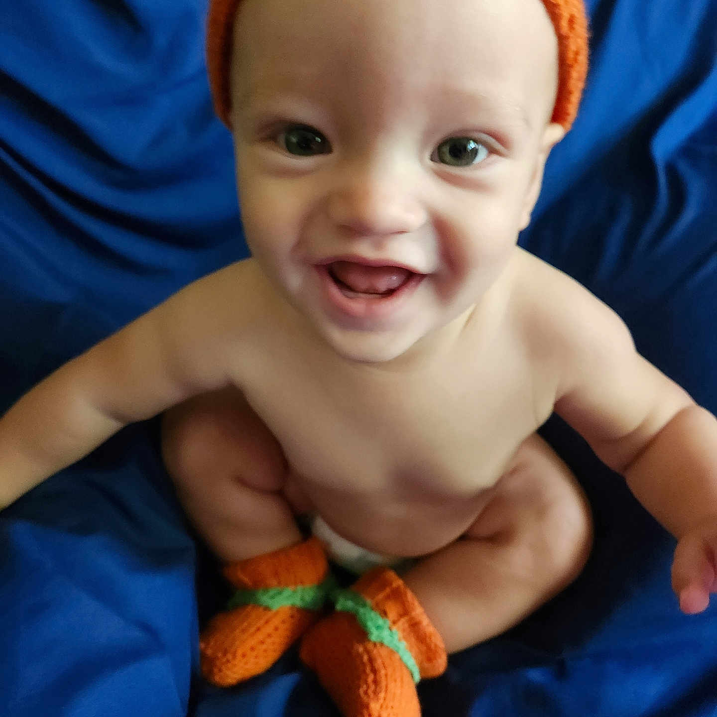 Ace is registered to the contest to win money with this photo: baby, beanie, bodypart, bonnet, cap, clothing, couch, face, finger, glove, hand, happy, hat, head, laughing, newborn, person, photography, portrait, smile