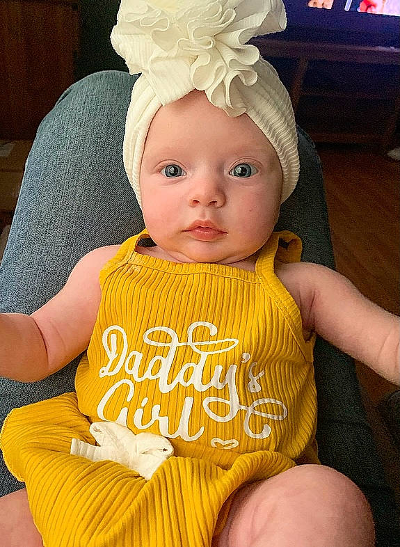 Bailey is registered to the contest to win money with this photo: baby, baby_toddler_clothing, cap, cheek, child, cool, costume_hat, eye, face, finger, fun, hairstyle, happy, head, headwear, human_body, jewellery, person, pink, skin