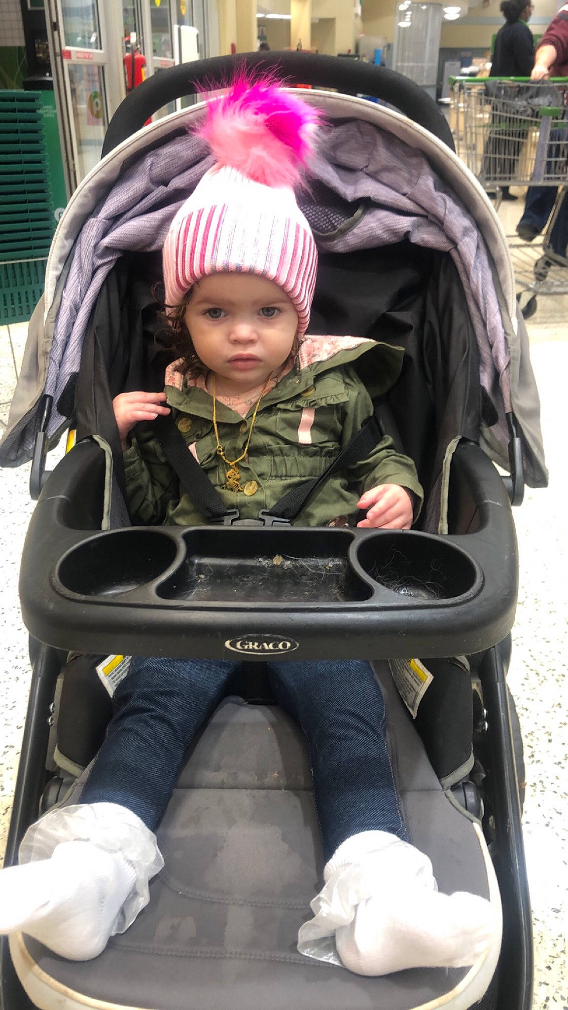 Nova is registered to the contest to win money with this photo: baby, baby_carriage, baby_products, chair, child, comfort, fun, headwear, helmet, lap, leisure, magenta, people, person, personal_protective_equipment, sitting, sneakers, street_fashion, toddler, wheel