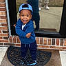 Icelee joined the competition — help win amazing prizes! child, toddler, smiling, blue_hoodie, blue_cap, sneakers, welcome_mat, brick_wall, glass_door, reflection, outdoor, concrete, person, casual_clothing, happy, pose, standing, curly_hair, footwear, daylight