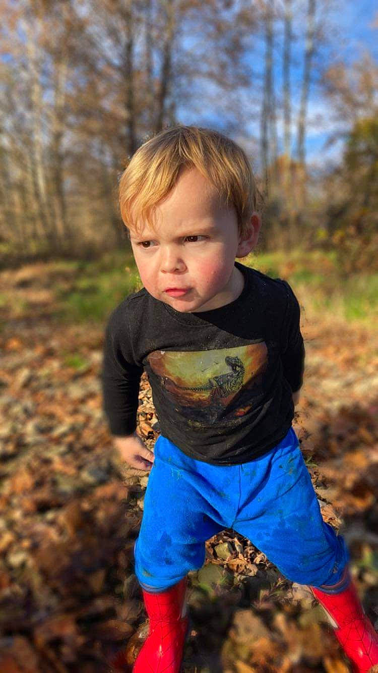 Jeremy is registered to the contest to win money with this photo: baby, baby_toddler_clothing, child, electric_blue, eye, forest, fun, grass, happy, people_in_nature, person, plant, recreation, sitting, sky, sleeve, soil, t_shirt, toddler, tree