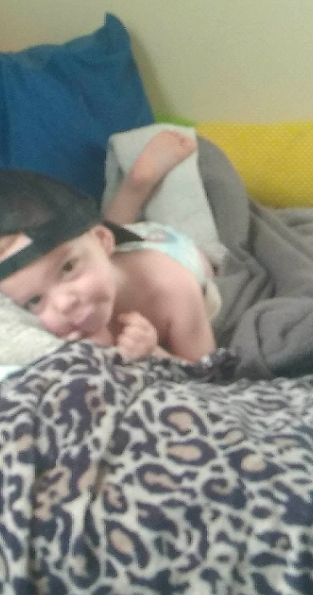 Jeremy joined the competition — help win amazing prizes! abdomen, baby, bed, bed_sheet, bedding, bedroom, bedtime, child, comfort, eyebrow, fun, gesture, headwear, human_leg, linens, nap, person, room, sitting, smile