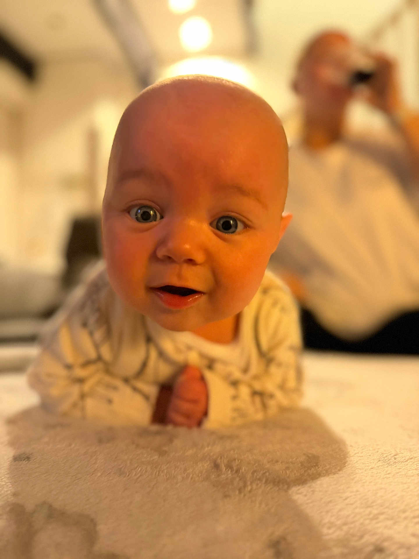 Cooper joined the competition — help win amazing prizes! baby, infant, face, eyes, mouth, skin, head, expression, lying_down, blurred_background, person, indoor, soft_light, focus, candid, cute, closeup, child, human, cozy