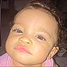 Serenity is registered to the contest to win money with this photo: child, toddler, face, portrait, curly_hair, expression, skin, eyes, nose, mouth, pink_clothing, indoor, closeup, head, young_child, innocence, baby, person, people, cute