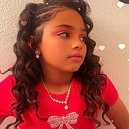Serenity joined the competition — help win amazing prizes! child, girl, portrait, curly_hair, jewelry, earrings, necklace, red_shirt, bow_design, heart_lights, wall, fashion, casual, young_person, looking_away, hairstyle, accessories, indoors, closeup, expression